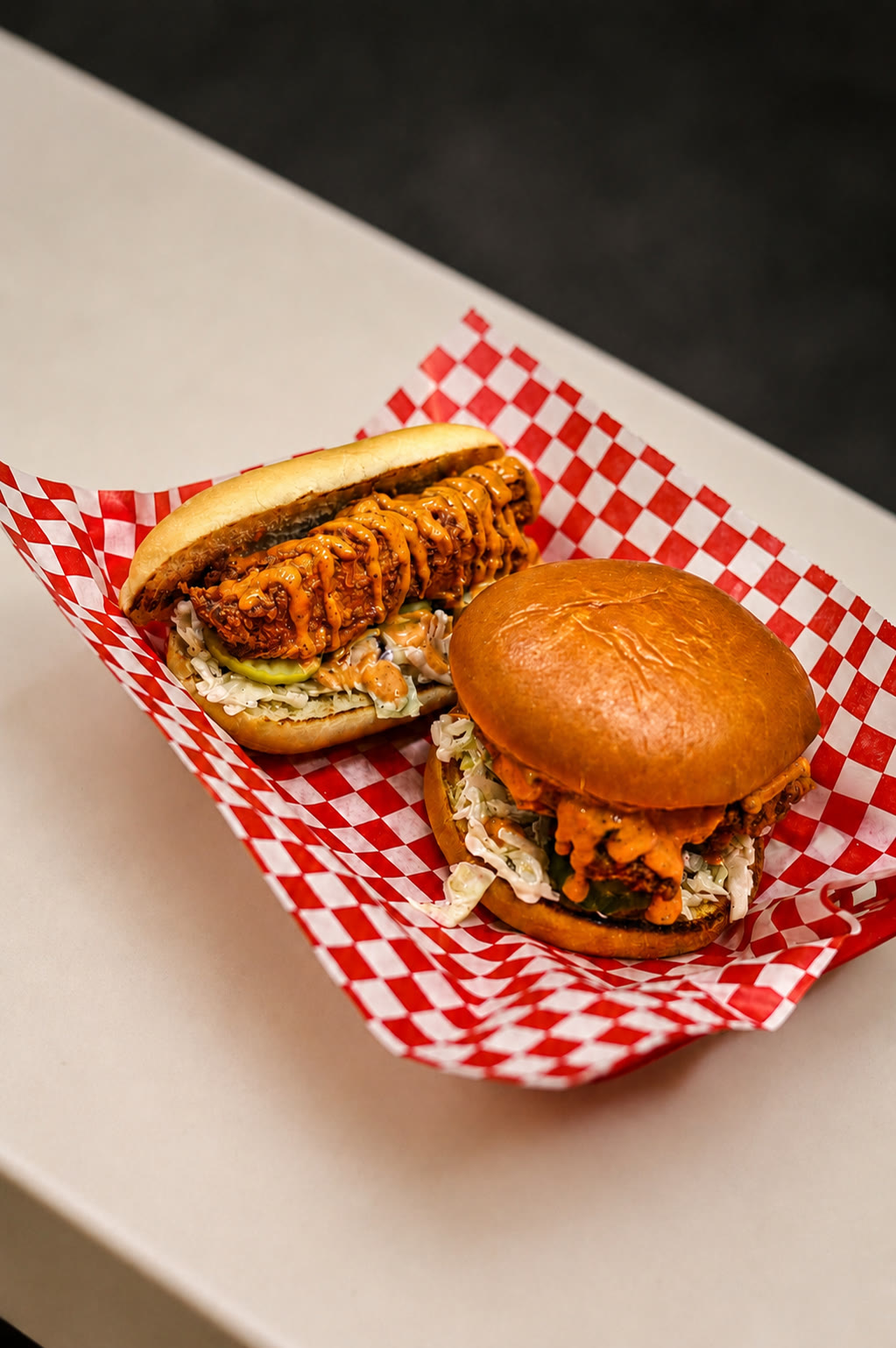 Kluckin Chicken sandwiches on checkered paper, photographed in the kitchen